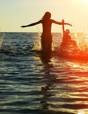 24178264 - silhouettes of young group of people jumping in ocean at sunset